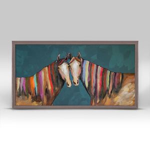 The tender touch of a cheek makes this scene of rainbow-maned horses emotional. Add this charming canvas wall art to your home for an added splash of color and nature design.