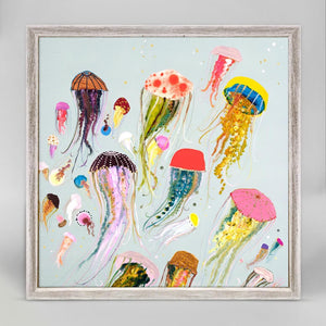 We love the pop of all these floating jellyfish. Vibrantly colorful they'll make you happy every day. Finished in our rustic white frame, this small artwork easily sits on your shelf or wall.