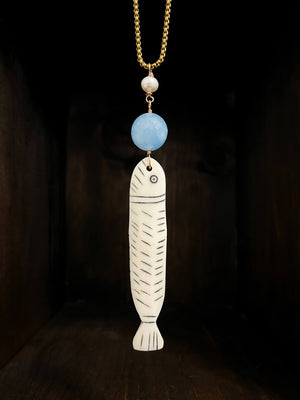 Long antique African carved bone fish fetish with Blue Chalcedony and Freshwater Pearl on a 30” long brass box chain with 24K Russian gold filled lobster clasp.