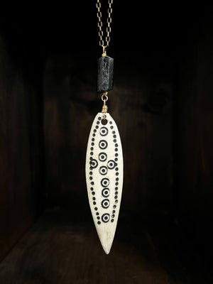 Long Antique African Bone Pendant with black dot marking paired with black tourmaline hanging on 30” long black enameled cut brass chain with 24K Russian gold filled lobster clasp