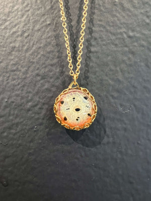 Hand blown borosilicate glass eye with multiple pupils caged in vintage brass filigree hanging on an 18" long brass chain.