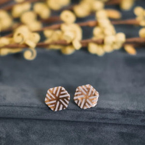 Accented Hexagon Earrings

Barçelona Inspirada  created by Quinn Smith of Remnant Studios 
Porcelain, 22K gold luster
.625" wide 
Surgical steel ear post.