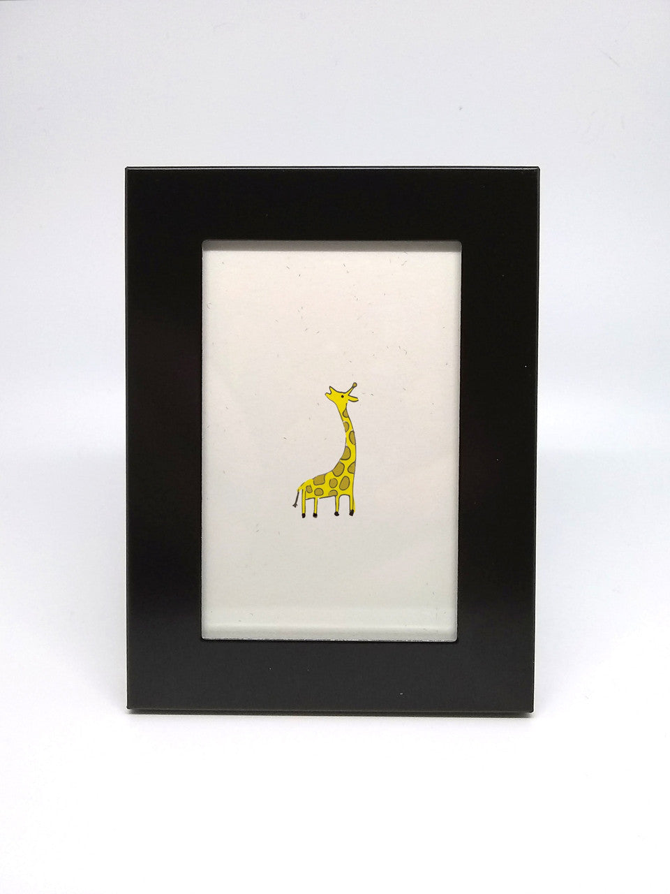 Giraffe Print by Elisa Wikey - Framed paper print. Are you an ant? Or do you live in a very small house? Or perhaps you just like charming tiny things? Hurray, finally something that fits your lifestyle! This is a 2.5"x3.5" tiny framed thing, the tiniest and framiest of all the things.