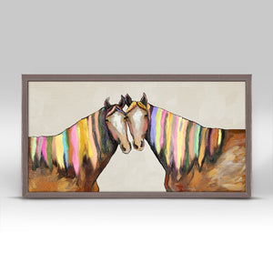 The tender touch of a cheek makes this scene of rainbow-maned horses emotional. Add this charming canvas wall art to your home for an added splash of color and nature design.